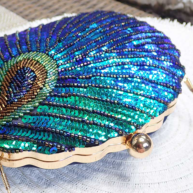 Close up on Teal Sequin Peacock Clutch with detailed beadwork design in feather shape, unique statement clutch bag elegant whimsical eclectic chic style by Montipi Australia