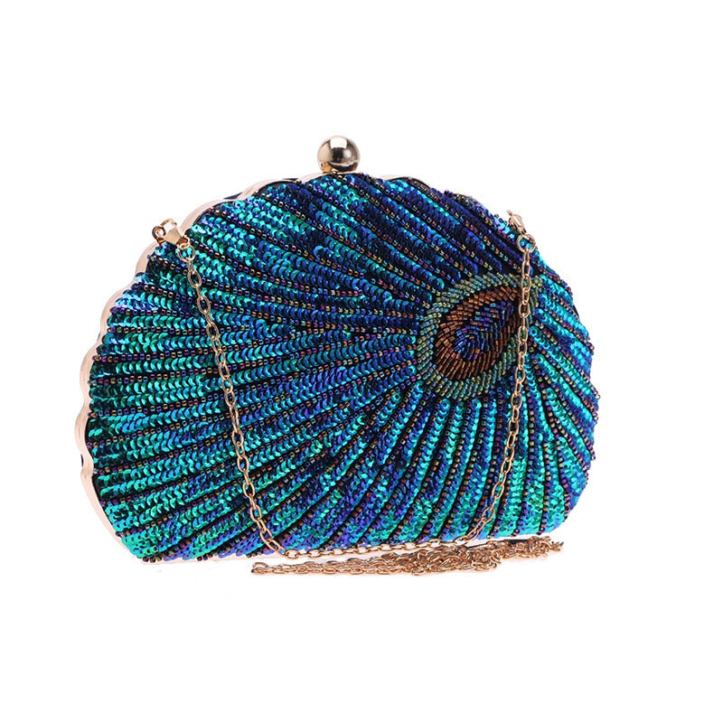 Close up on Teal Sequin Peacock Clutch with detailed beadwork design in feather shape and gold chain straps, unique statement clutch bag elegant whimsical eclectic chic style by Montipi Australia