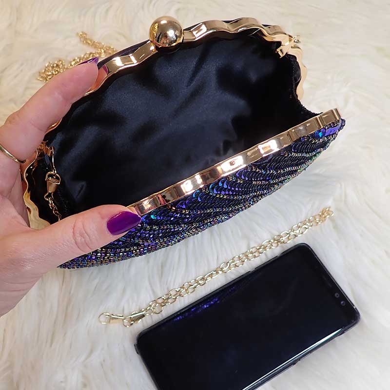 Close up on Teal Sequin Peacock Clutch with detailed design in feather shape and silky black interior, large enough to fit a smart phone, provided with two chain straps for versatile styles, unique statement clutch bag elegant whimsical eclectic chic style by Montipi Australia