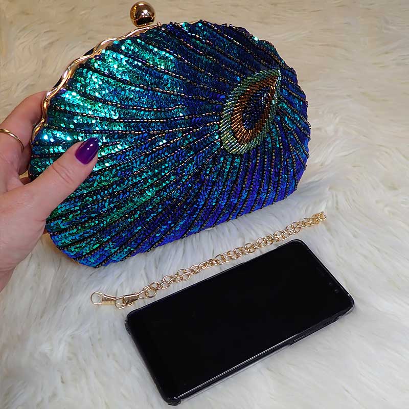 Close up on Teal Sequin Peacock Clutch with detailed design in feather shape and silky black interior, large enough to fit a smart phone, provided with two chain straps for versatile styles, unique statement clutch bag elegant whimsical eclectic chic style by Montipi Australia