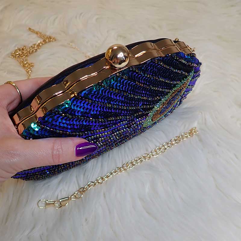 Close up on Teal Sequin Peacock Clutch with detailed design in feather shape and silky back in dark blue, provided with two chain straps for versatile styles, unique statement clutch bag elegant whimsical eclectic chic style by Montipi Australia