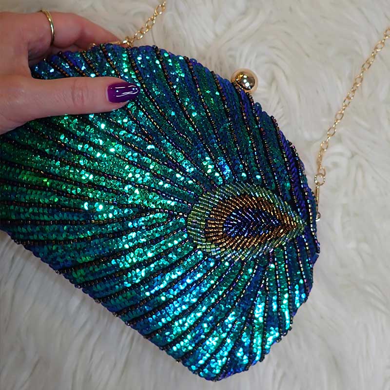 Close up on Teal Sequin Peacock Clutch with detailed beadwork design in feather shape, chain shoulder strap provided, unique statement clutch bag elegant whimsical eclectic chic style by Montipi Australia