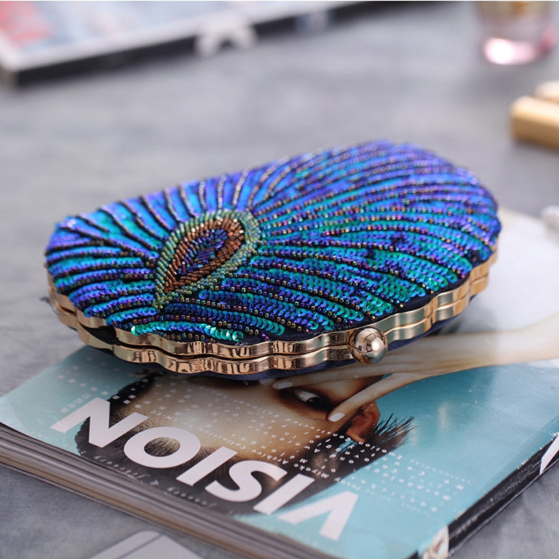 Close up on Teal Sequin Peacock Clutch with detailed beadwork design in feather shape, external structure in shell shape, unique statement clutch bag elegant whimsical eclectic chic style by Montipi Australia