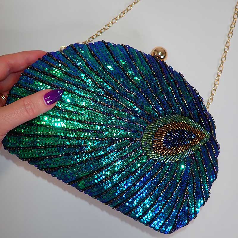 Close up on Teal Sequin Peacock Clutch with detailed beadwork design in feather shape, chain shoulder strap provided, unique statement clutch bag elegant whimsical eclectic chic style by Montipi Australia