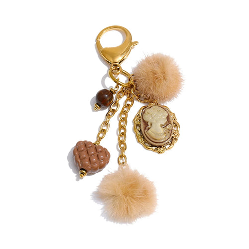 cute vintage inspired gold keychain with pompom, beads and cameo to add a boheme chic style to your handbag by Montipi