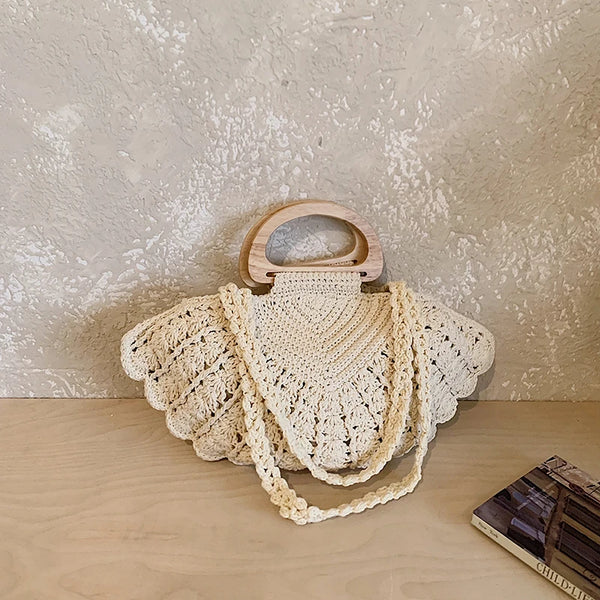 Cream crochet shell-inspired boho handbag with textured woven details and wooden handles