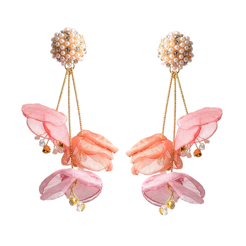 Pair of pink floral earrings with pearl-like beads on a white background elegant wedding accessories