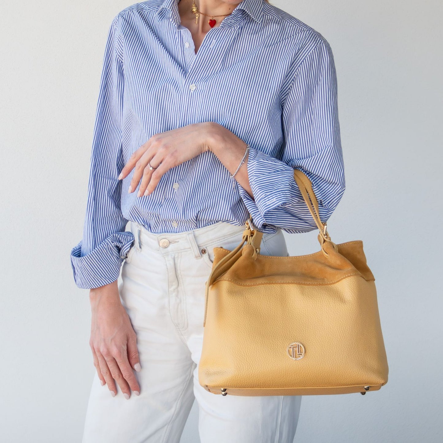 Bohemian chic suede leather shoulder bag styled for Riviera look