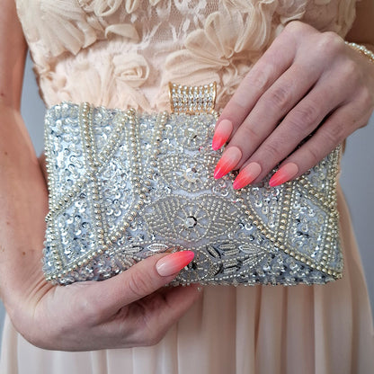 elegant silver beaded clutch bag with pink Ombre nails and channel nude pink dress  the perfect match by Montipi