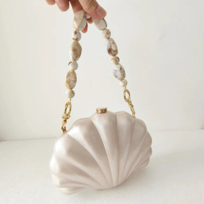 Elegant and chic Mermaid Pearl Shell Clutch Bag with chic beaded handles resembling marble stones and gold tone hardware by Montipi Australia