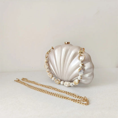 Elegant and chic Mermaid Pearl Shell Clutch Bag with removable beaded handle and gold chain shoulder strap by Montipi Australia