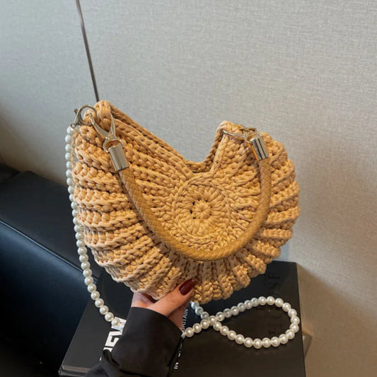 Fossil Seashell Bag in light brown soft woven cotton with shell shape by Montipi, styled in earthy beach tones – perfect for boho luxe, coastal chic, and summer outfits.