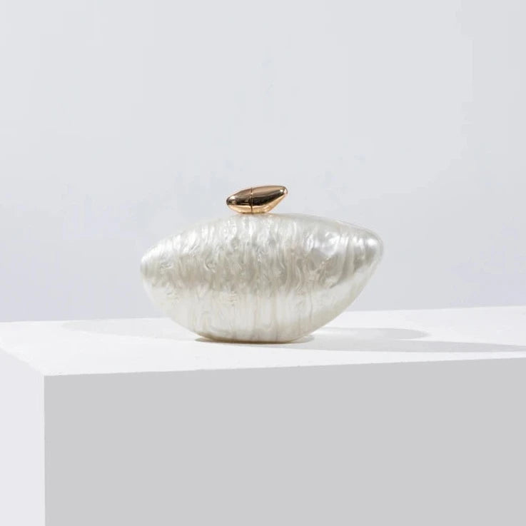 White seashell clutch bag with a dreamy pearl acrylic finish, gold hasp closure, and chain strap – perfect for weddings, soirées, and beachside style by Montipi Australia