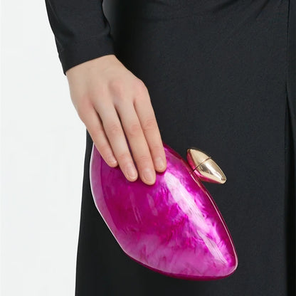 Hot pink seashell clutch bag with a dreamy pearl acrylic finish, gold hasp closure, and chain strap – perfect for weddings, soirées, and beachside style by Montipi Australia