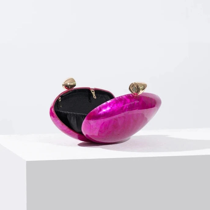 Hot pink seashell clutch bag with a dreamy pearl acrylic finish, gold hasp closure, and chain strap – perfect for weddings, soirées, and beachside style by Montipi Australia