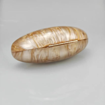 Gold seashell clutch bag with a dreamy pearl acrylic finish, gold hasp closure, and chain strap – perfect for weddings, soirées, and beachside style by Montipi Australia