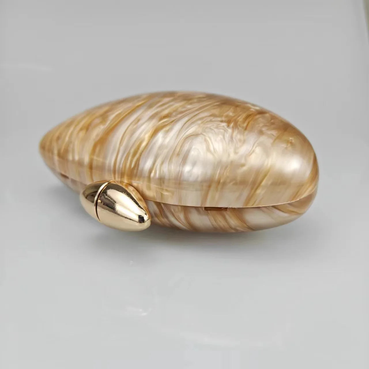 Gold seashell clutch bag with a dreamy pearl acrylic finish, gold hasp closure, and chain strap – perfect for weddings, soirées, and beachside style by Montipi Australia