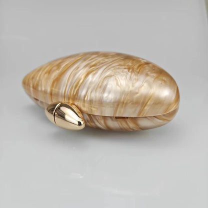 Gold seashell clutch bag with a dreamy pearl acrylic finish, gold hasp closure, and chain strap – perfect for weddings, soirées, and beachside style by Montipi Australia