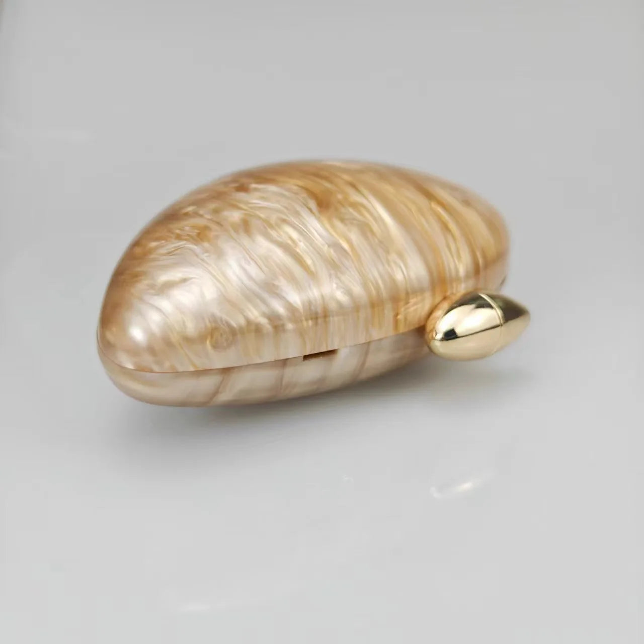 Gold seashell clutch bag with a dreamy pearl acrylic finish, gold hasp closure, and chain strap – perfect for weddings, soirées, and beachside style by Montipi Australia