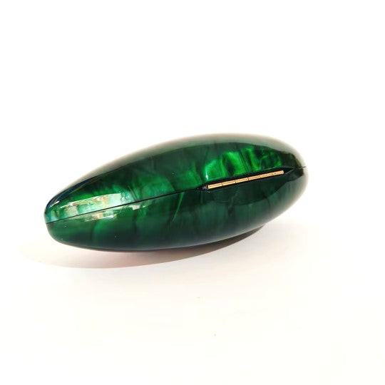 Vibrant green seashell clutch bag with a dreamy pearl acrylic finish, gold hasp closure, and chain strap – perfect for weddings, soirées, and beachside style by Montipi Australia