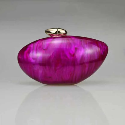 Hot pink seashell clutch bag with a dreamy pearl acrylic finish, gold hasp closure, and chain strap – perfect for weddings, soirées, and beachside style by Montipi Australia