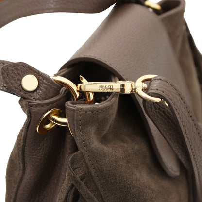 Close-up of the Nomad Dark Taupe Suede Leather Fringe Bag showing detachable adjustable leather strap, gold-tone hardware, and refined stitching by Montipi.