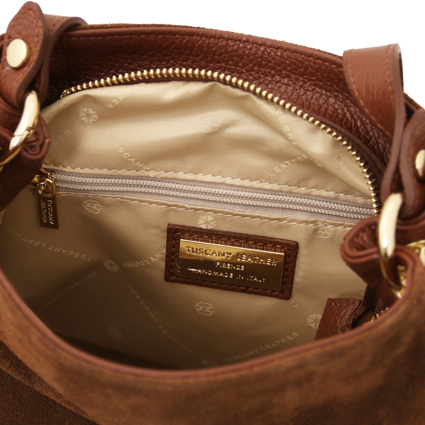 Close-up of the Nomad Brown Suede Leather Fringe Shoulder Bag interior showing logo tag, zip pocket, and soft beige lining by Montipi.