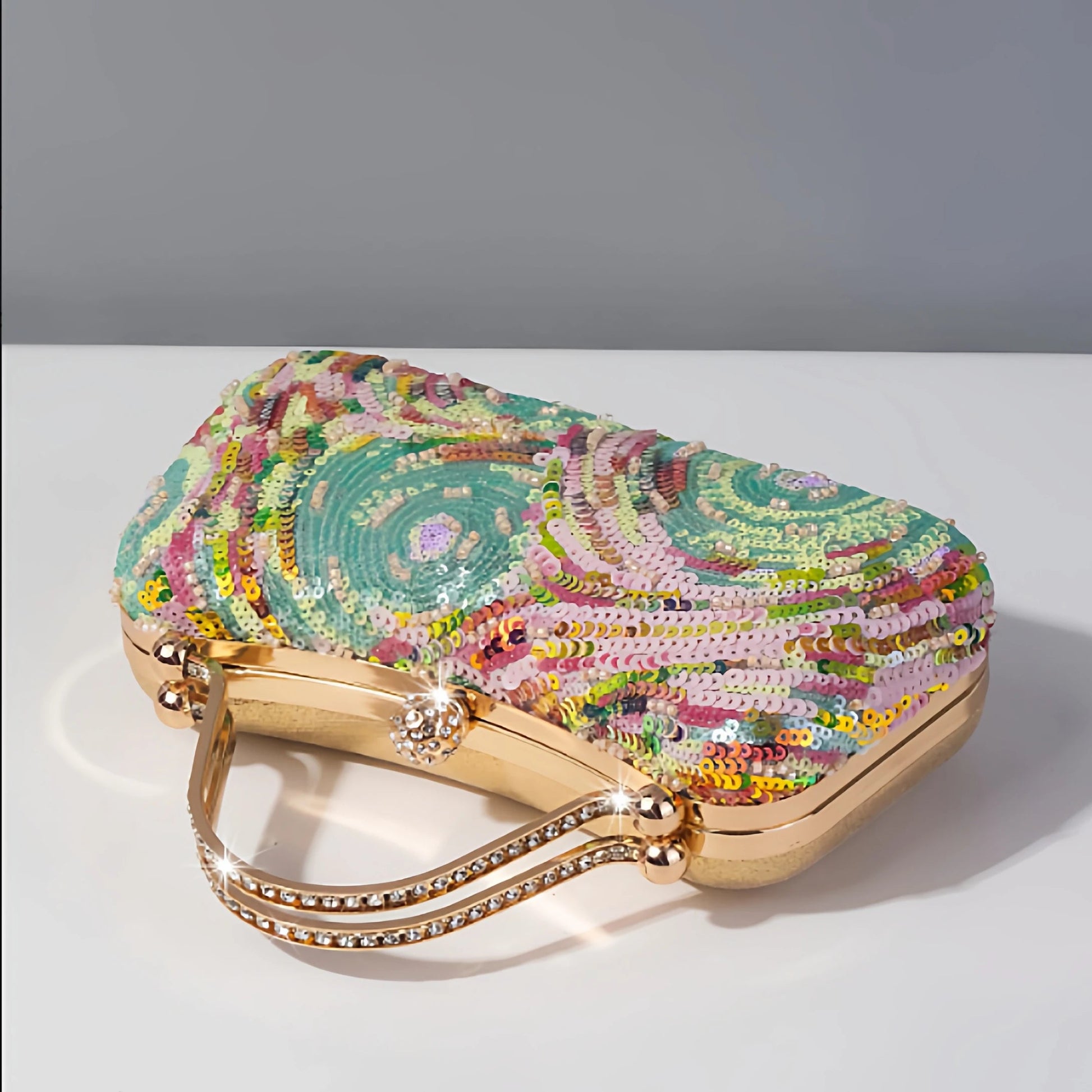 top view of pastel clutch bag with colourful swirling sequin beadwork in pink, mint blue, and soft tones.