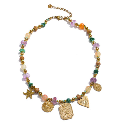 Oasis Spell Necklace with multicolour translucent beads and gold charms—evil eye, starfish, heart and medallions—on an adjustable gold chain; boho-chic style.