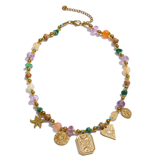Oasis Spell Necklace with multicolour translucent beads and gold charms—evil eye, starfish, heart and medallions—on an adjustable gold chain; boho-chic style.