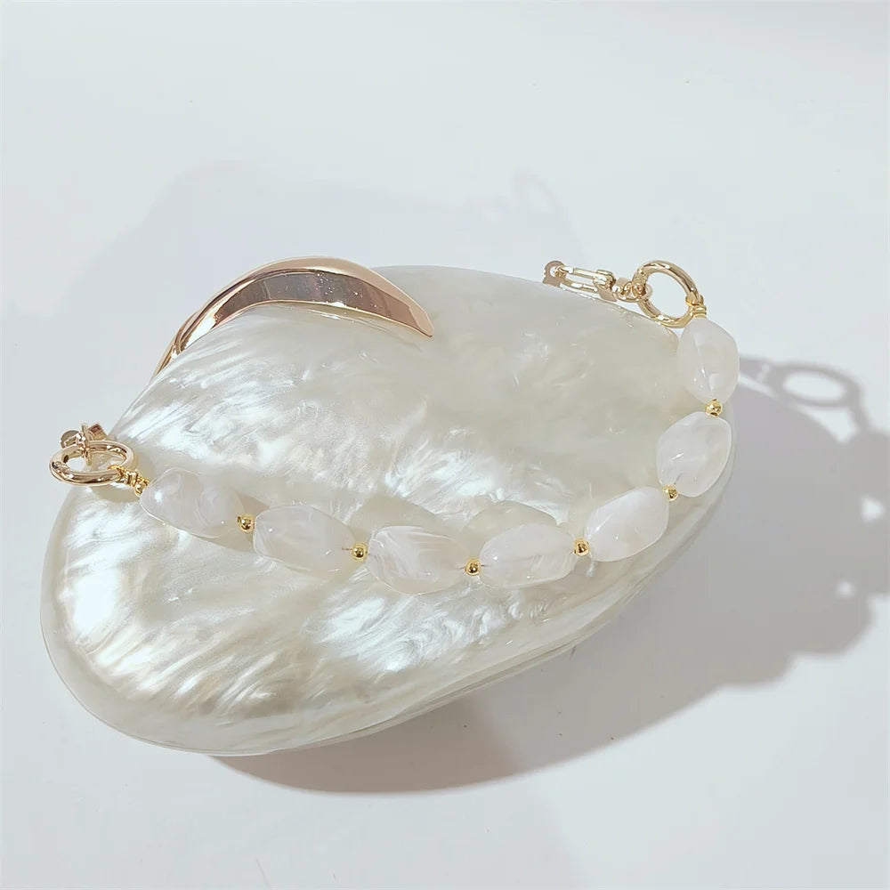 elegant and dreamy white pearl clutch with gold leaf decoration hasp closure and beaded handle with white stones, a dreamy mother of pearl effect white clutch  perfect for beach weddings by Montipi