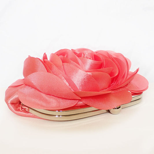 Top view of the Rose Chic Petal Clutch in a Couture pose. A delicate rose-shaped clutch bag with layered petal detailing in a soft, romantic hue. The elegant floral design mimics the texture of blooming petals, creating a timeless statement piece. Set against a refined backdrop, the clutch exudes femininity and sophistication, perfect for weddings, cocktail events, and special occasions. Rose Chic Petal Clutch Bag in rose pink by Montipi Australia