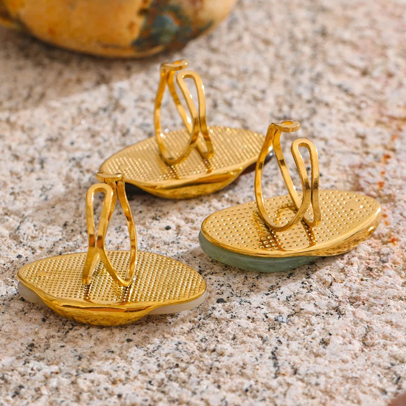 Solara Gemstone Rings collection displayed up side down adjustable ring detailing on textured surface – gold plated statement rings