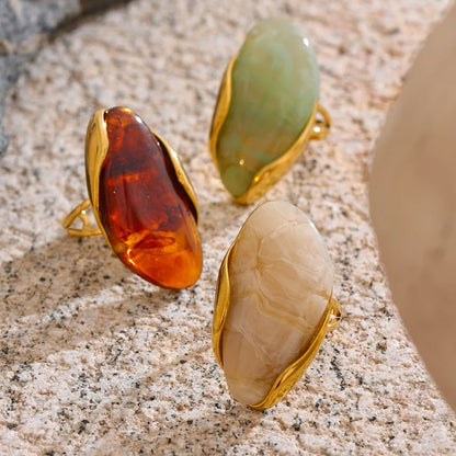 Solara Gemstone Rings collection displayed on textured surface – gold plated statement rings