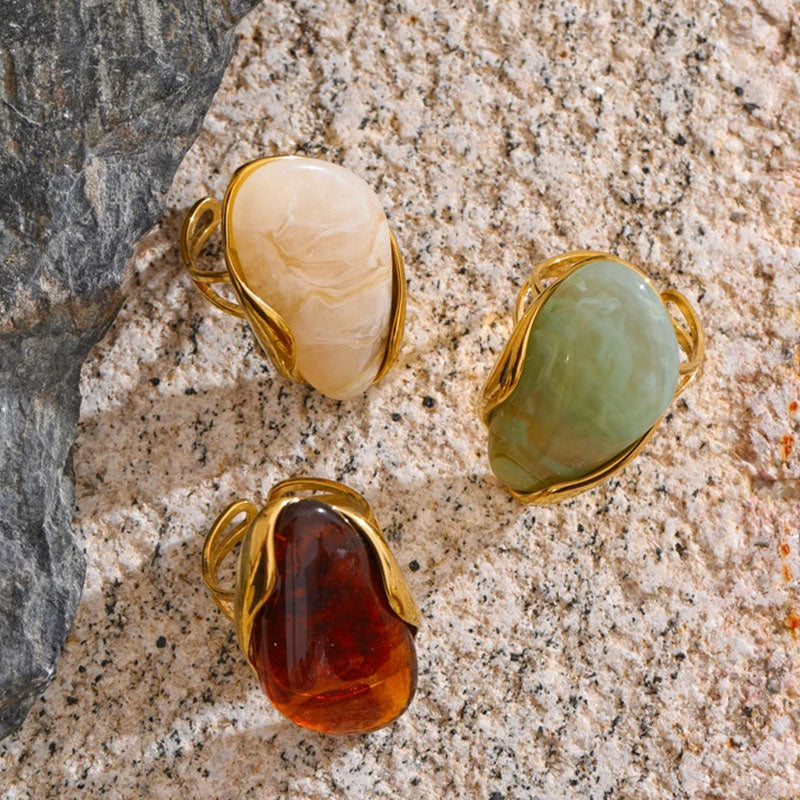 Solara Gemstone Rings collection displayed on textured surface – gold plated statement rings