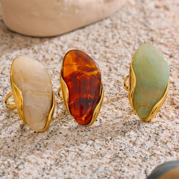Solara Gemstone Rings collection displayed on textured surface – gold plated statement rings