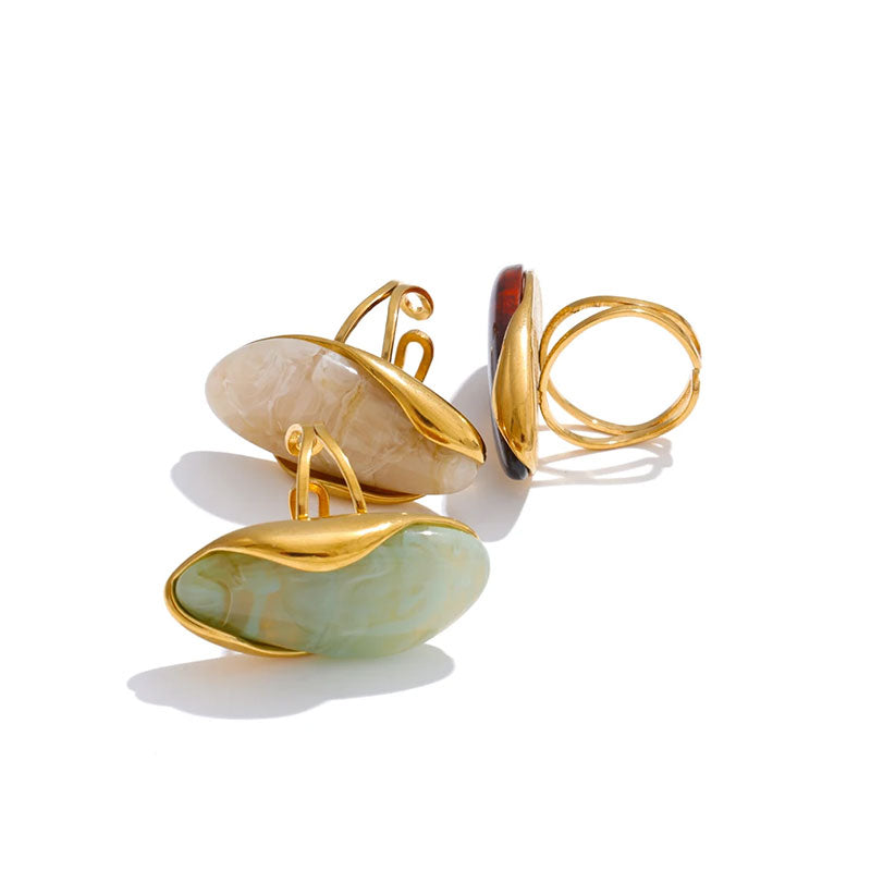 Solara Gemstone Ring collection flat lay – Amber, Aqua Green, and Ivory stones