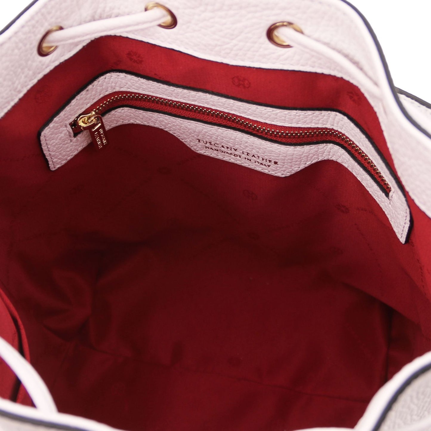 Interior view of the TL Leather Bucket Bag in white by Montipi Australia, featuring a bold red lining, spacious compartment, and secure internal zip pocket. Crafted from premium Italian pebbled leather with gold-tone hardware, this chic bucket bag blends elegance with everyday practicality.