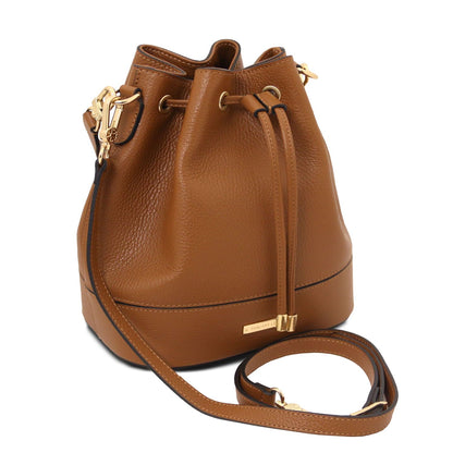 Angled view of the TL Leather Bucket Bag in cognac brown by Montipi Australia, showcasing its premium Italian pebbled leather, structured silhouette, and elegant drawstring closure with gold-tone hardware. A versatile handbag with a detachable top handle and adjustable shoulder strap, designed for everyday sophistication and effortless style.