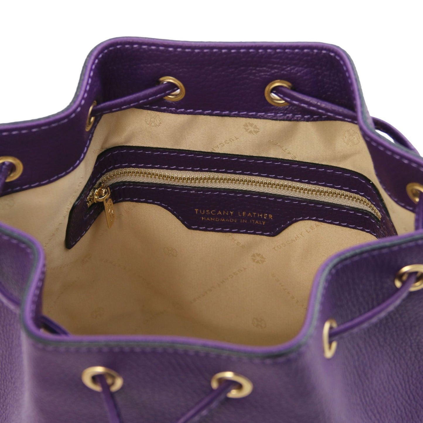 Interior view of the TL Leather Bucket Bag in purple by Montipi Australia, featuring a beige lining, spacious compartment, and secure internal zip pocket. Crafted from premium Italian pebbled leather with gold-tone hardware, this chic bucket bag blends elegance with everyday practicality.