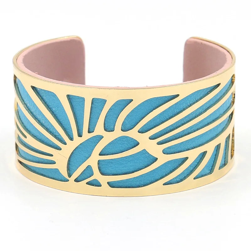 Gold leaf cut-out cuff with bright blue leather underlay, front view.