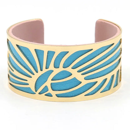 Gold leaf cut-out cuff with bright blue leather underlay, front view.