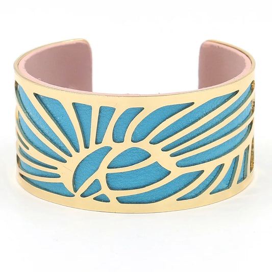 Gold leaf cut-out cuff with bright blue leather underlay, front view.